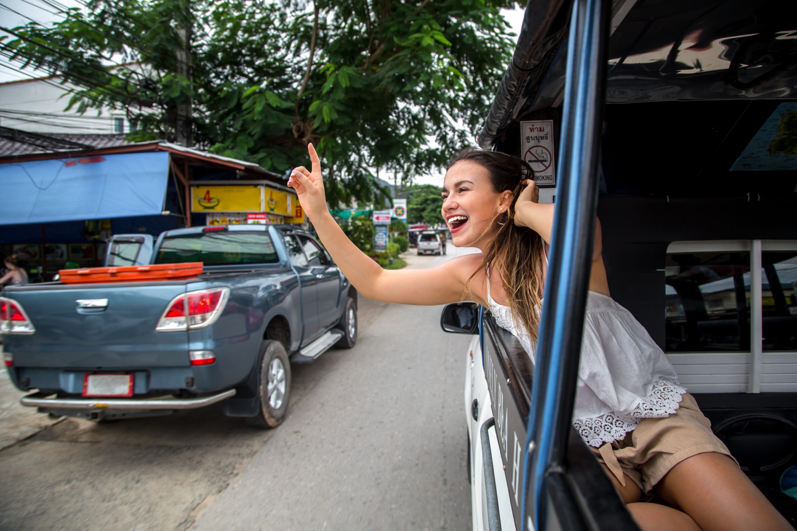 the girl with the emotions shows hand sign in a taxi travel concept